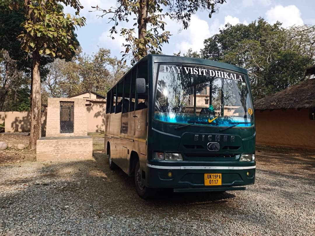 Tourists on a thrilling canter safari in the dhikala zone of jim corbett national park, surrounded by dense forest and wildlife.