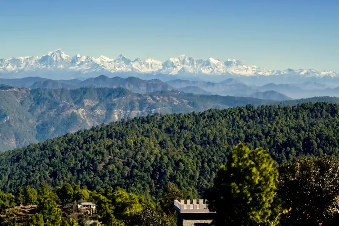 A mountain range with trees and a building