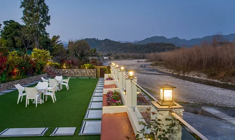 A lawn with chairs and lights on it